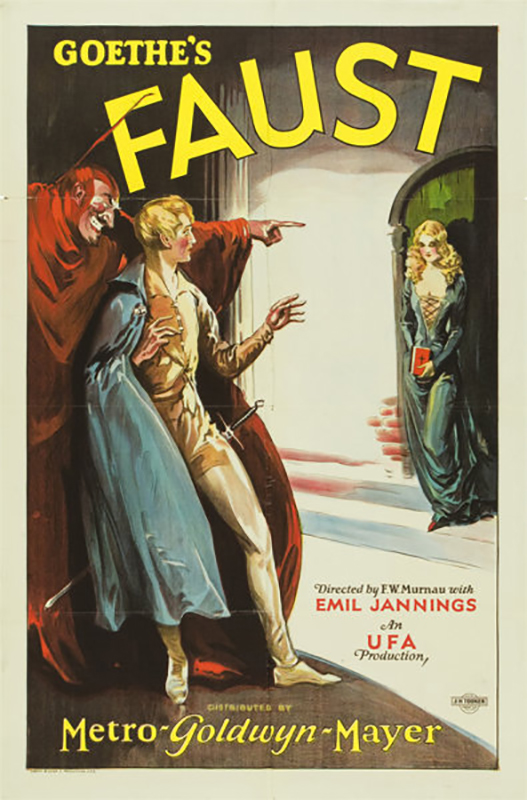 Cartaz de movimento contendo o desenho de um jovem de aparência assustada com um demônio sorridente parado atrás dele e apontando para uma jovem usando um vestido decotado.