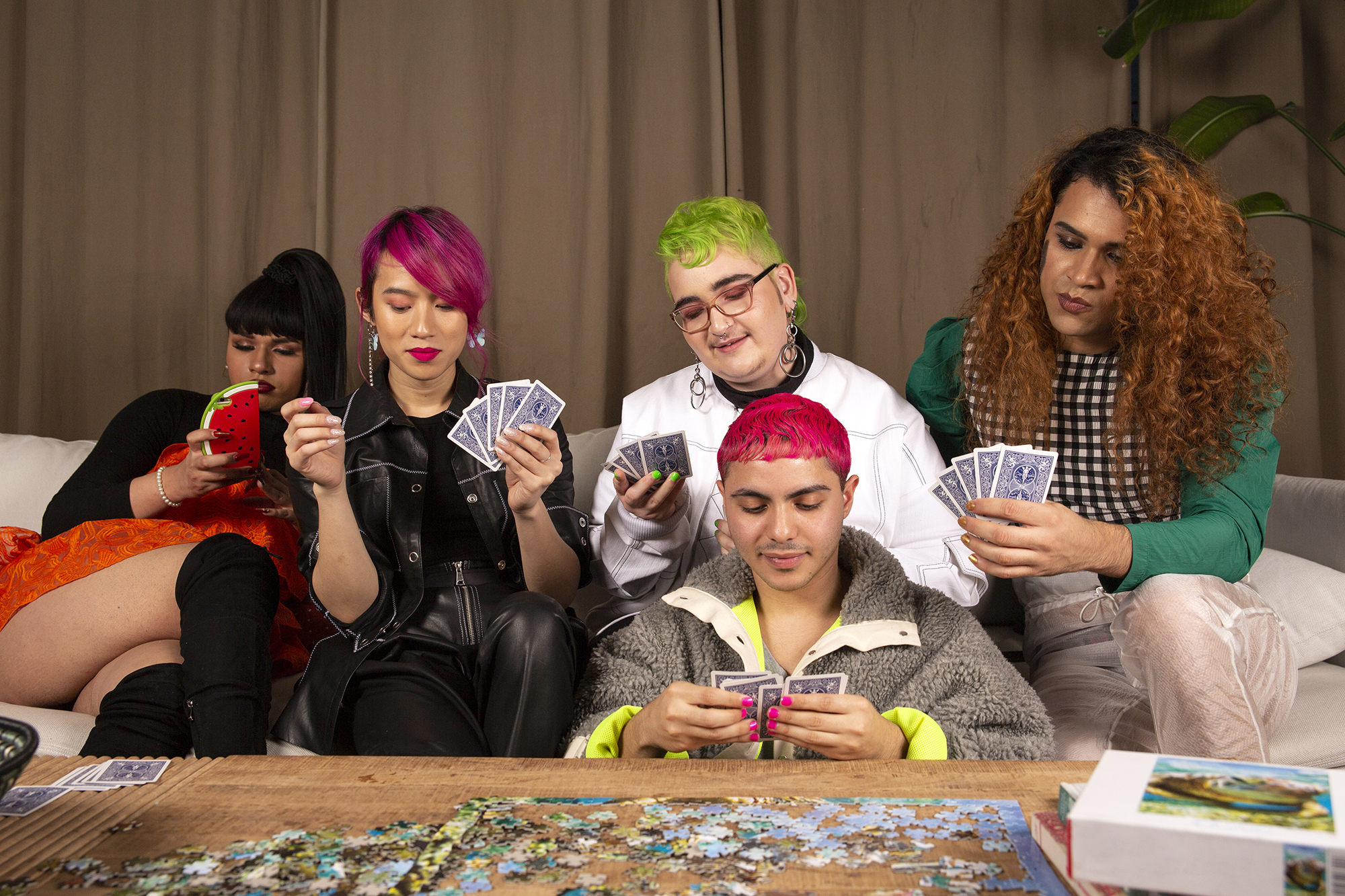 A group of teenagers playing a card game. 