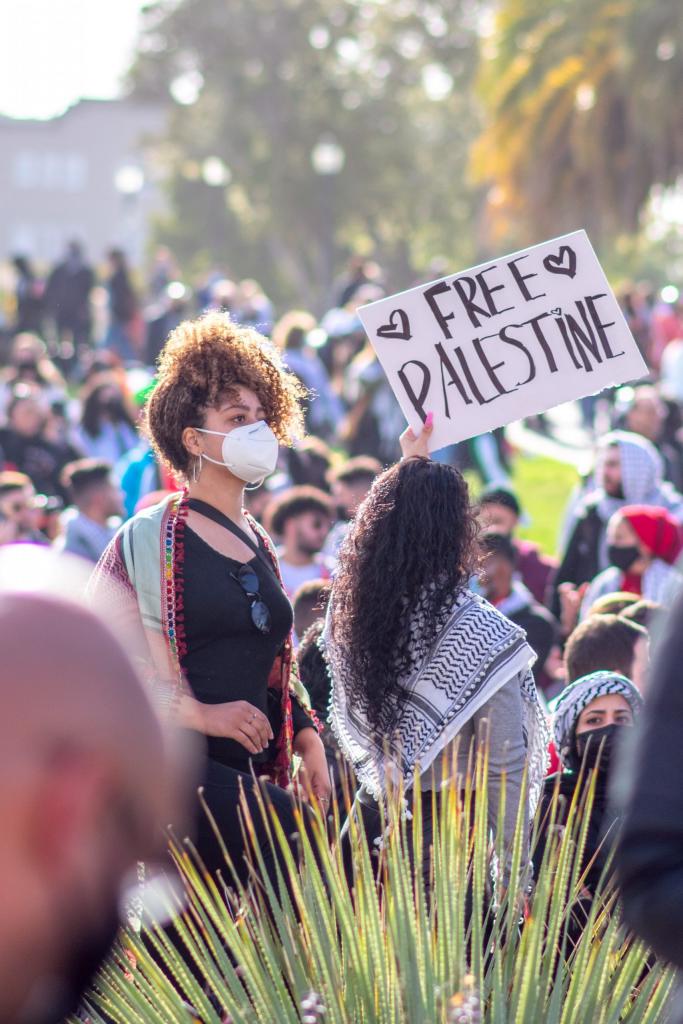 woman holding sign that reads 'Free Palestine'