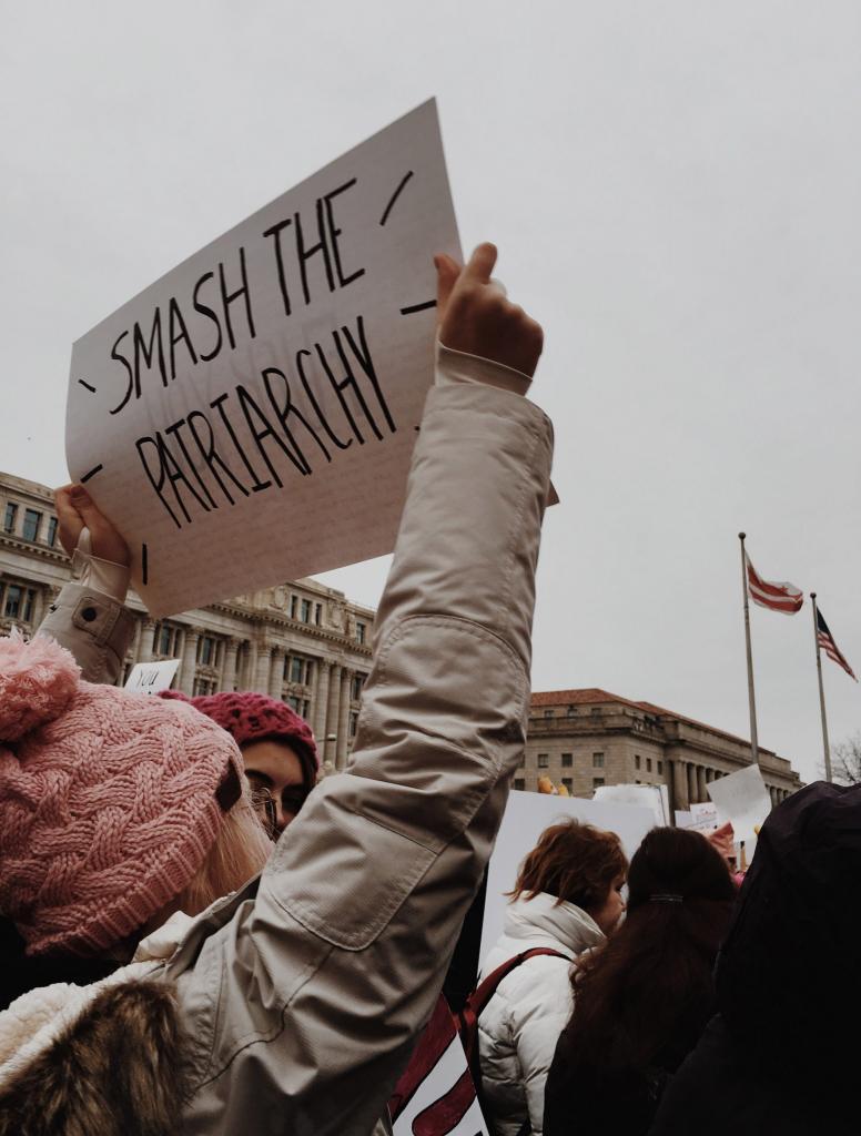 woman holding sign that reads 'Smash the patriarchy'