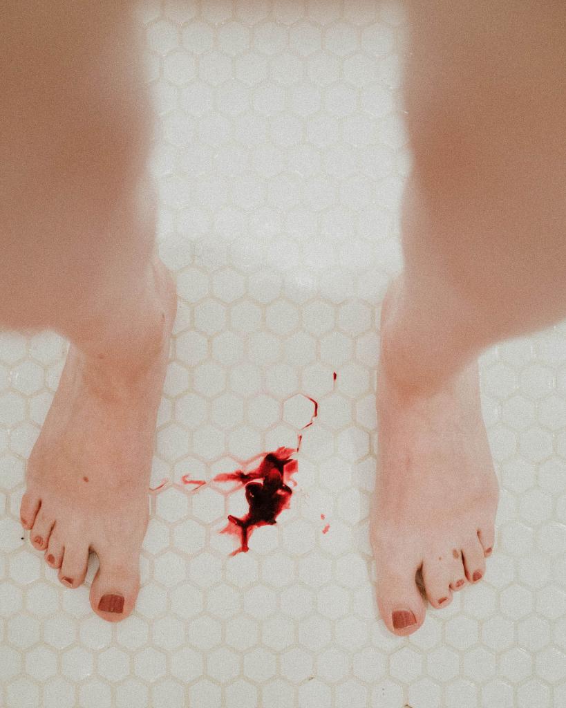 pair of legs with blood on floor