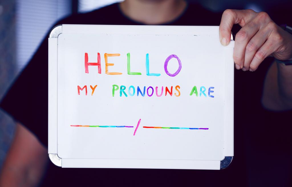 whiteboard that reads in multicolor 'Hello, my pronouns are'