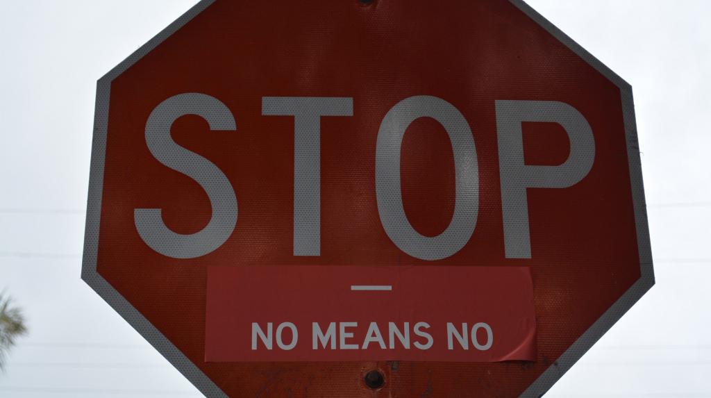 stop sign with additional label that reads 'No means no'