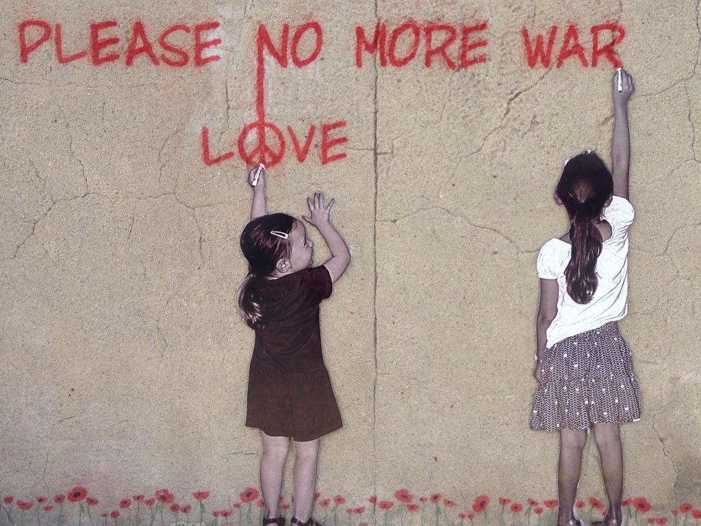 mural of two girls writing 'Please no more war' and 'Love'