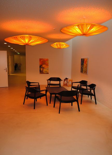 Circular shaped ceiling lights let off an amber glow.