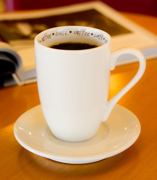Coffee in a coffee mug on a table.