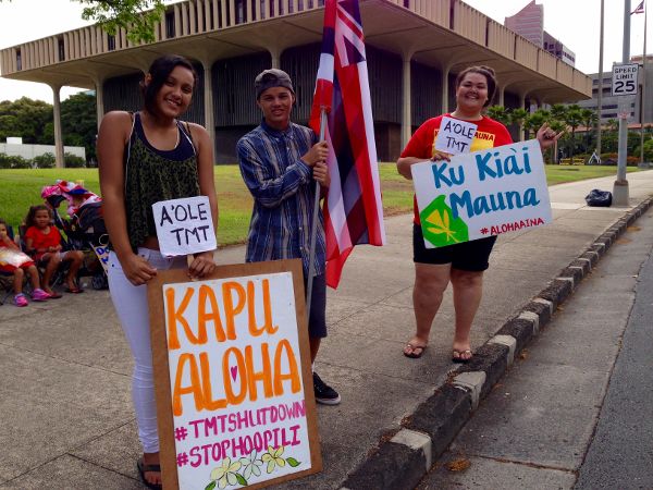 Protesters opposing the thirty meter telescope project are seen demonstrating outside the Hawaii State Capitol.