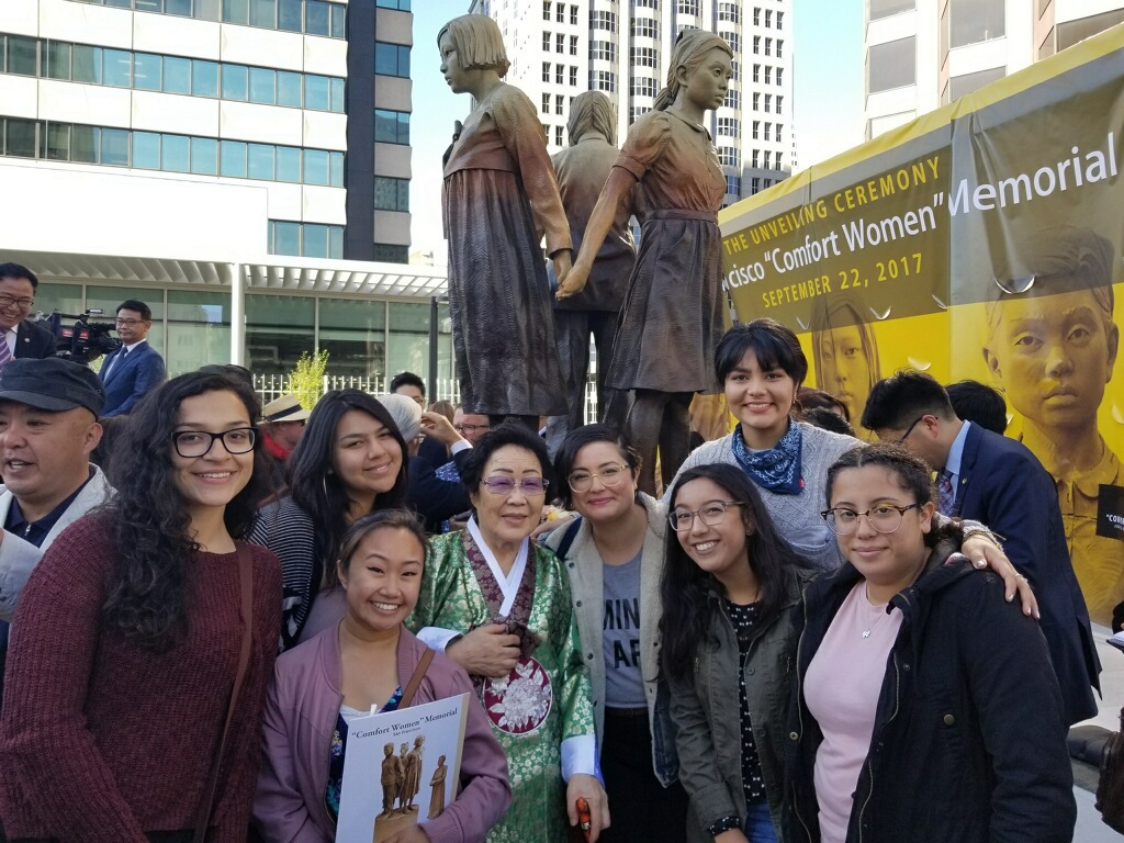 A group of women post in front of the San Francisco "Comfort Women" memorial