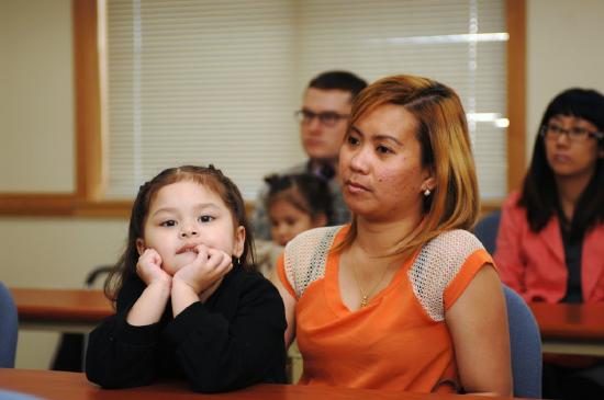 Mother and daughter at a USCIS meeting providing answers about citizenship and immigration for soldiers and families at Army Community Services in Seoul