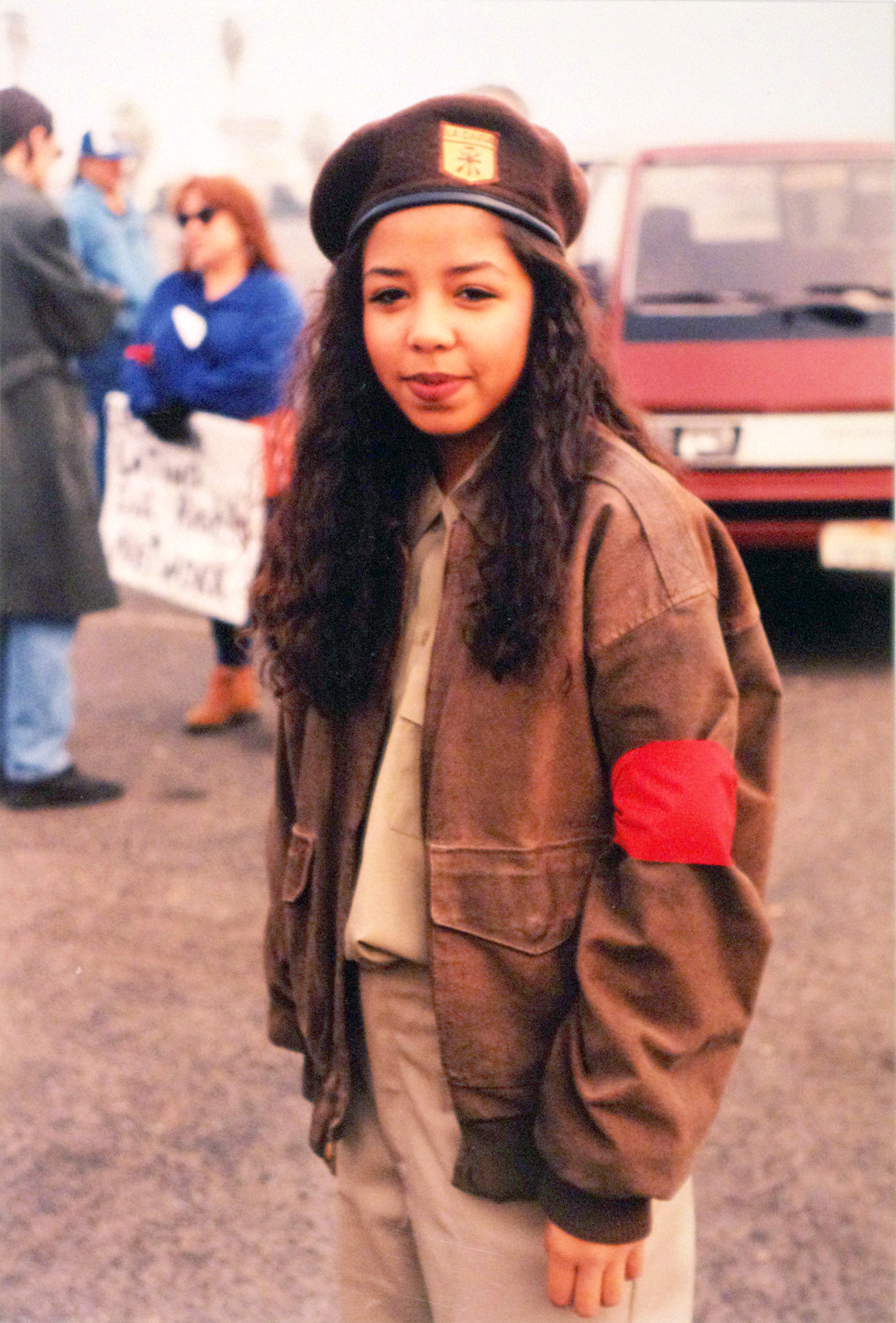 A girl wearing a brown beret uniform in preparation for a protest