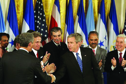 Uma imagem de George W. Bush apertando a mão de legisladores e funcionários da administração.