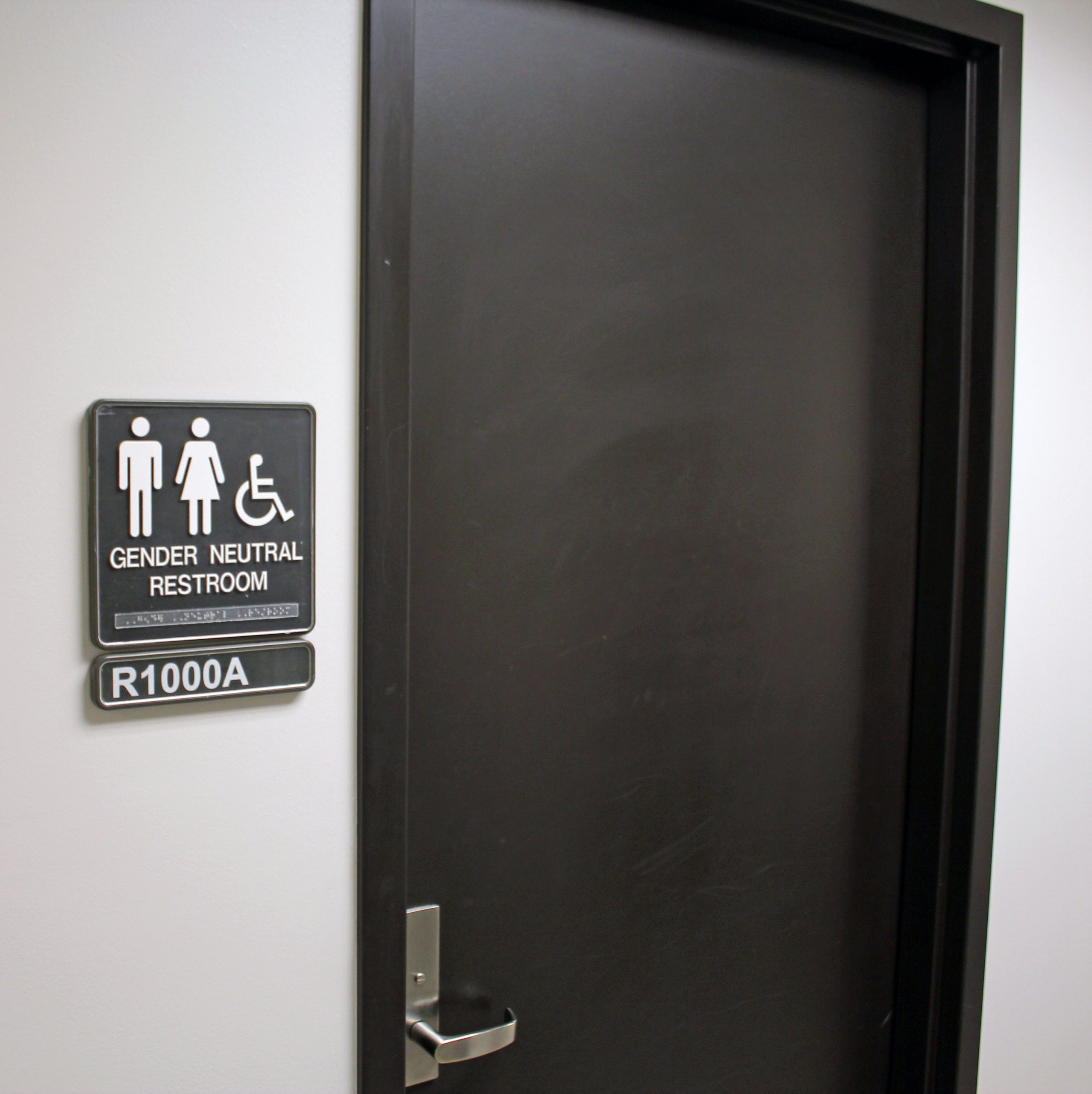 A sign next to a door that says "GENDER NEUTRAL RESTROOM."