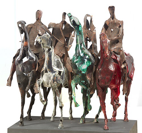 A sculpture of four figures on horseback