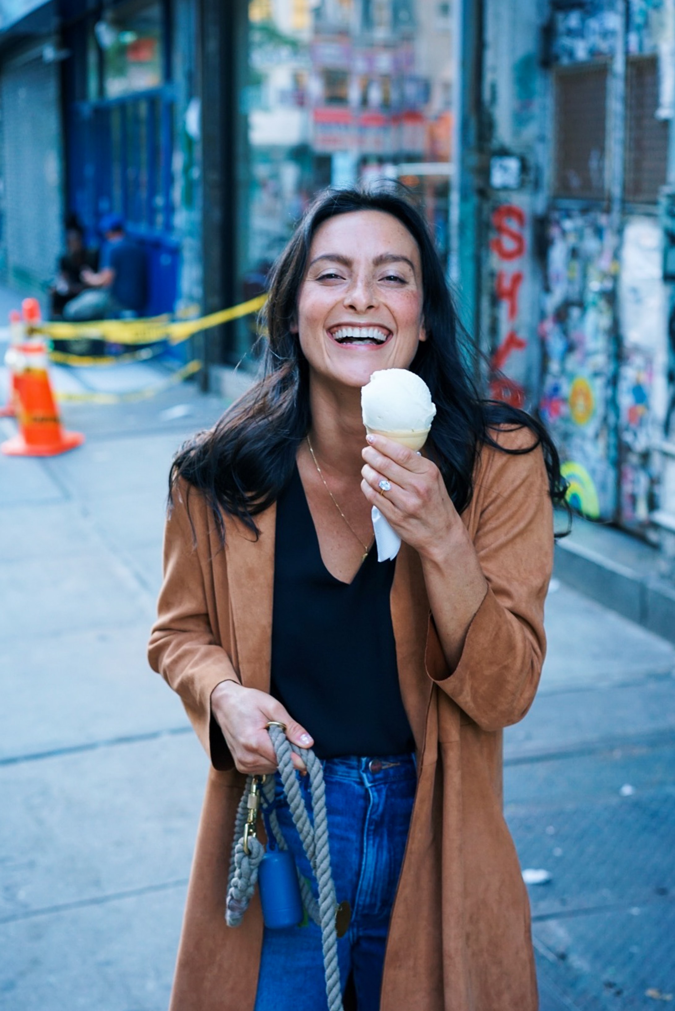 woman holding an ice cream cone and smiling