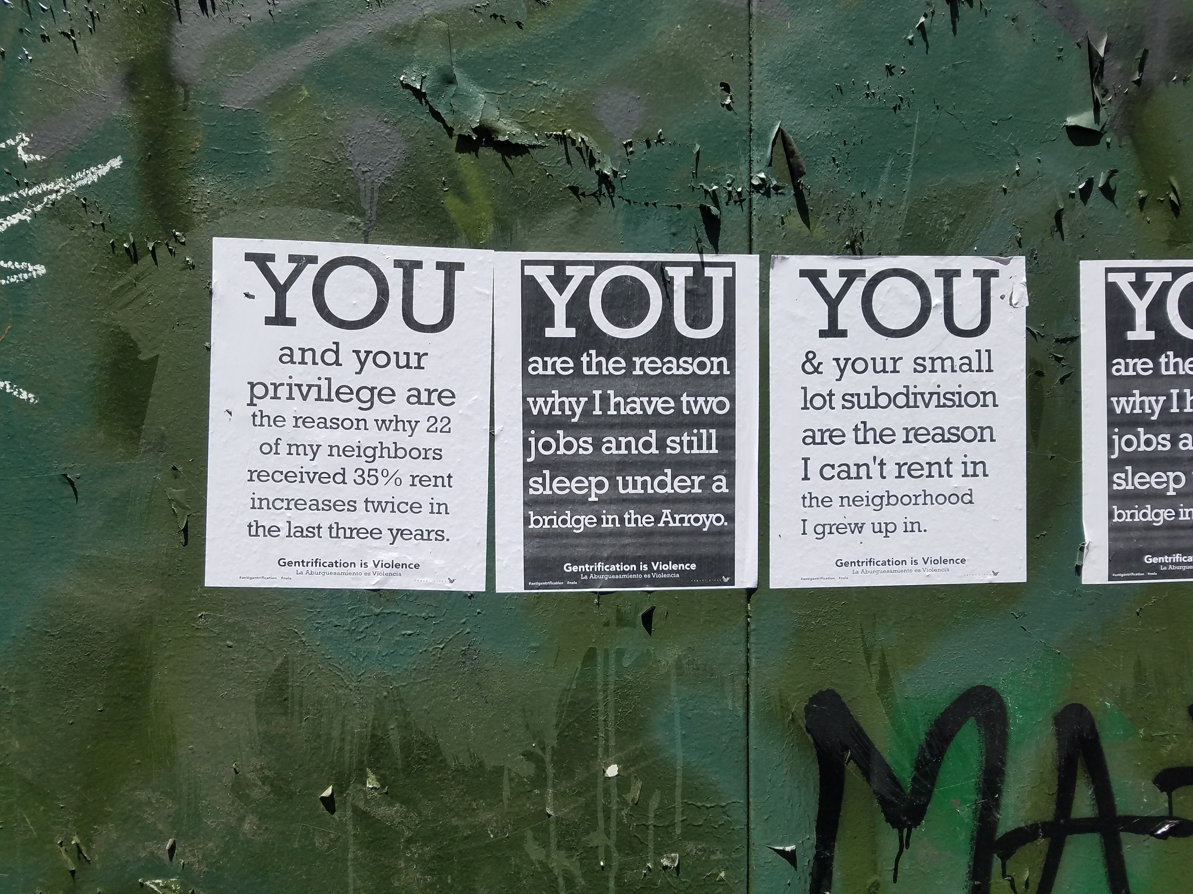 Anti-genetrification flyers posted on a wall
