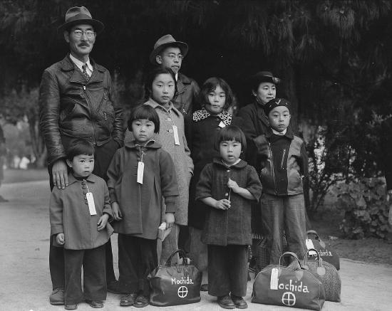 A Japanese American family of nine, photographed with their packed bags and tagged by the government