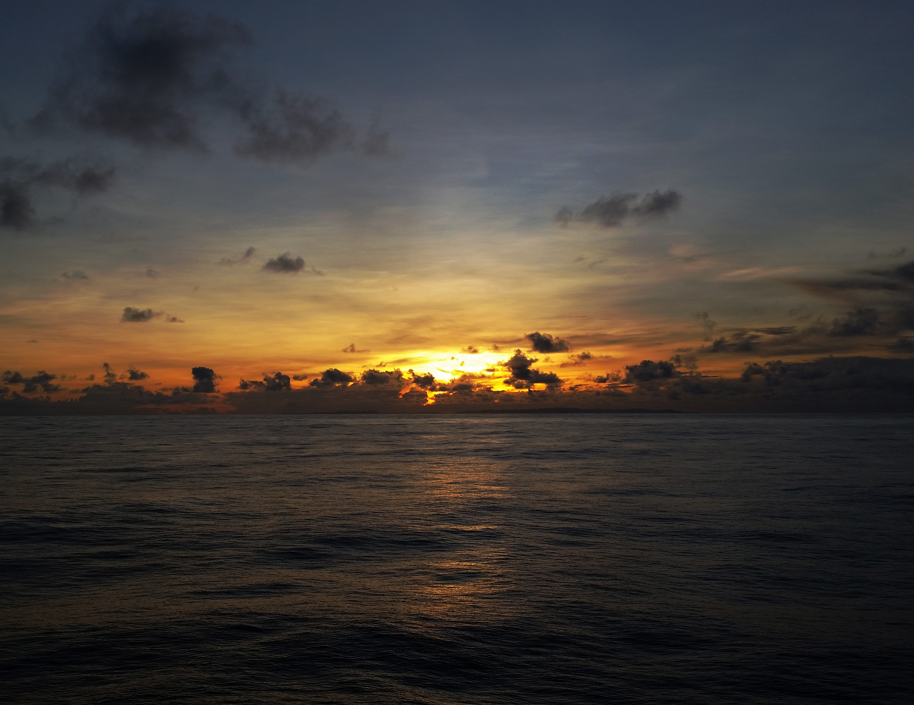 the rising sun over the ocean