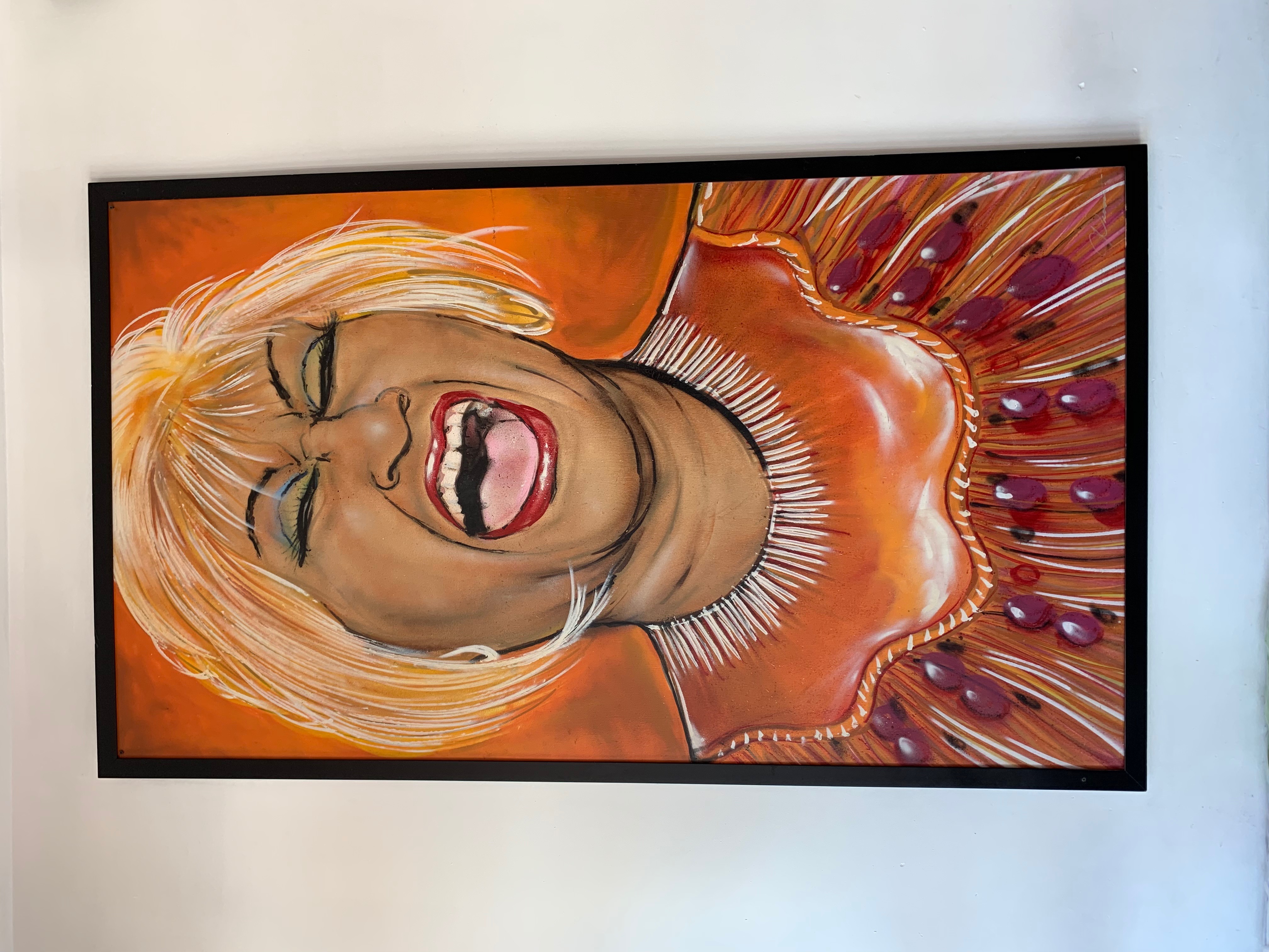 A portrait of Celia Cruz wearing a blond wing and singing passionately