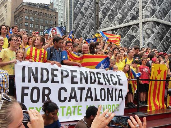 Crowd of people with Catalonian flags and banner.