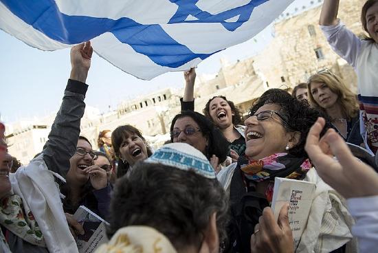 Women celebrating with the flag of Israel