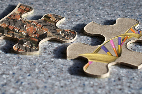 Deux pièces de puzzle sont présentées ; l'une représente des images de maisons et l'autre représente un brin d'ADN hélicoïdal.