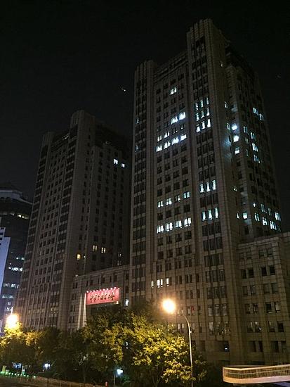 Tall buildings in an evening photo.