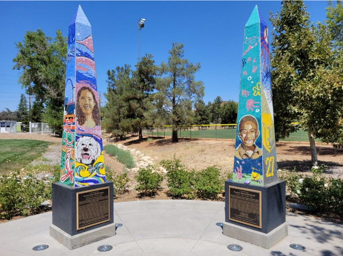 Two colorful obelisks, each about four feet high, with pictures depicting what each murdered student loved (decorative).