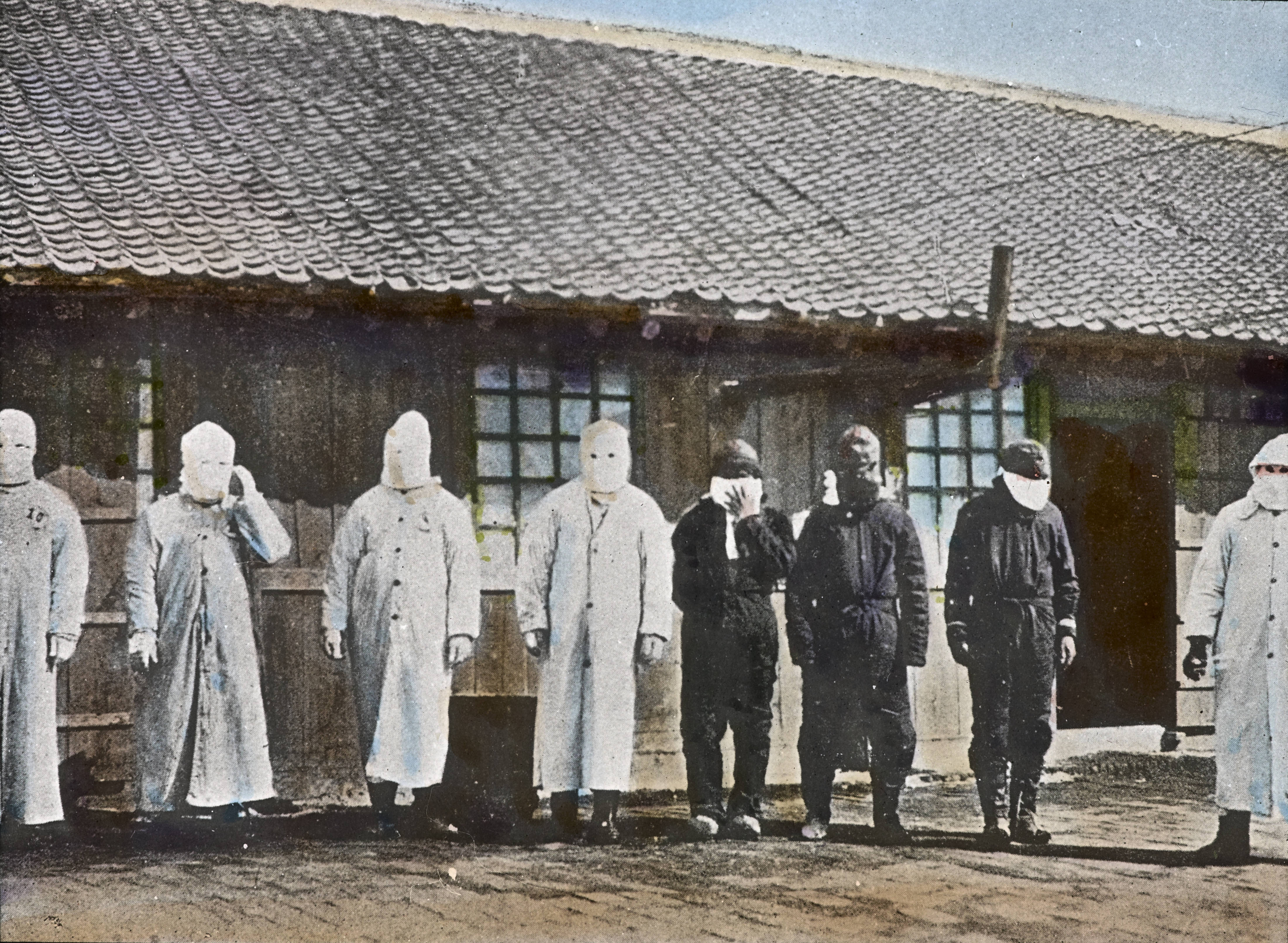 several men wearing the original masks created by Dr. Wu Ling-teh 