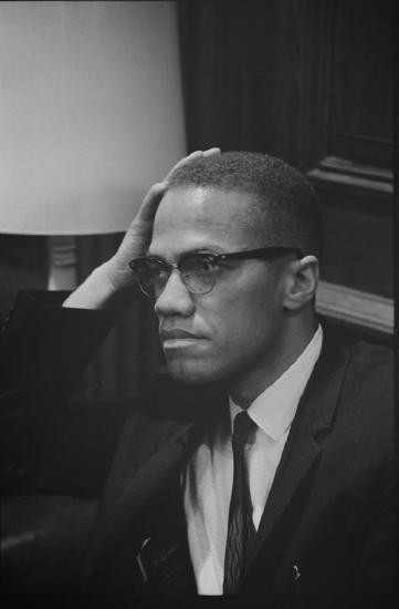 Picture of Malcolm X as he waits at the King Press Conference