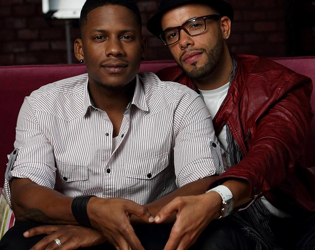A Black gay couple sitting together