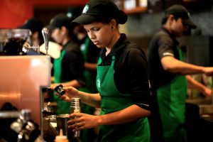 Young woman working as a barista