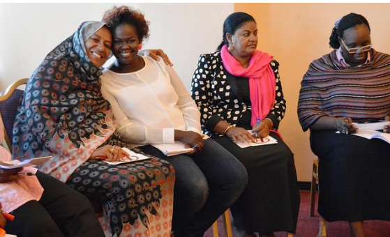 A group of seated women attending a support group.