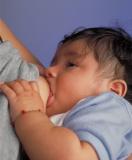 An infant breastfeeding.
