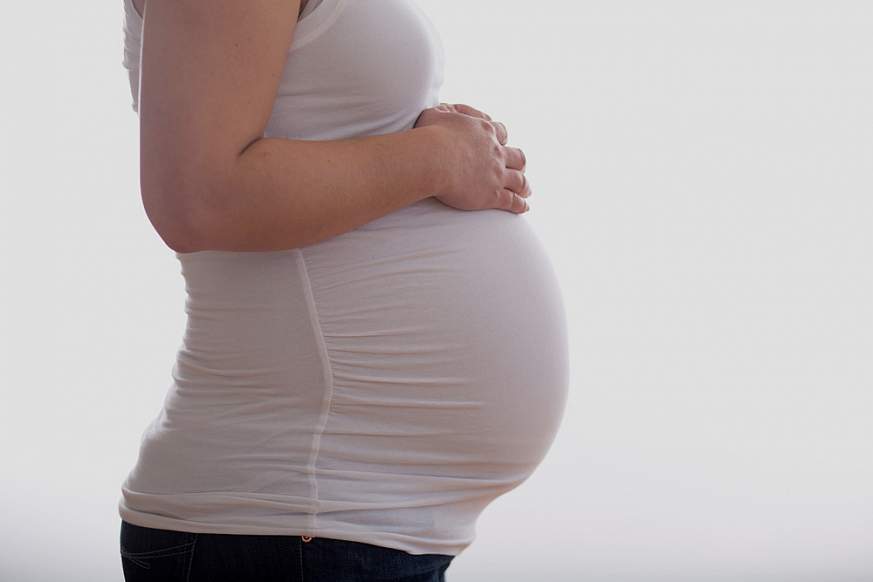 Image of a pregnant woman, showing only her torso and abdomen.