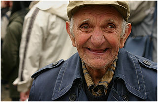 A smiling older man outdoors.