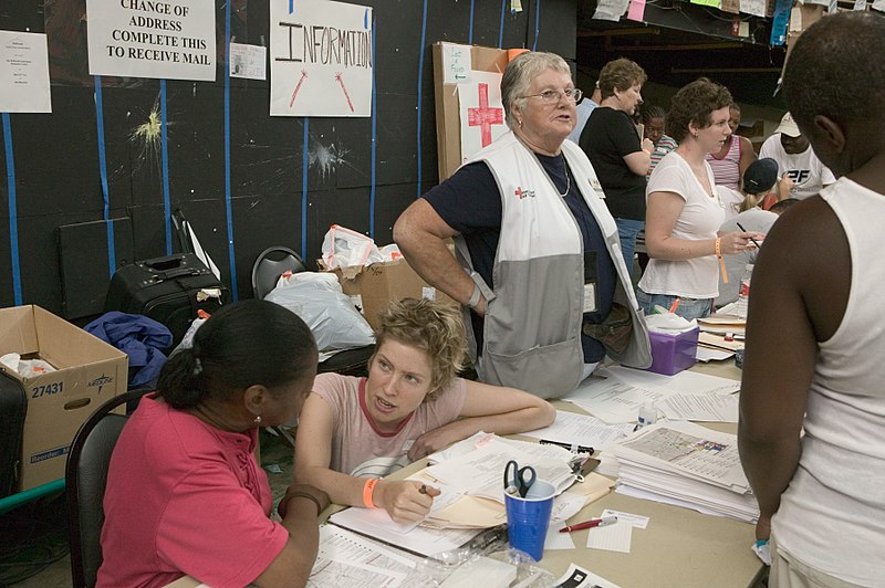 FEMA volunteers assist Hurricane Katrina survivors in Houston with getting information and filling out paperwork. Older adults are among the FEMA volunteers.
