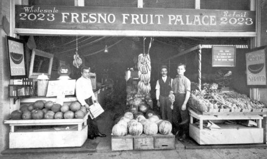 Open storefront of Fresno Fruit Palace showing melons and other fruit for sale