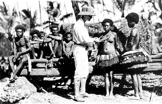 black and white photo of Bronislaw Malinowski (center) with Trobriand Islanders.