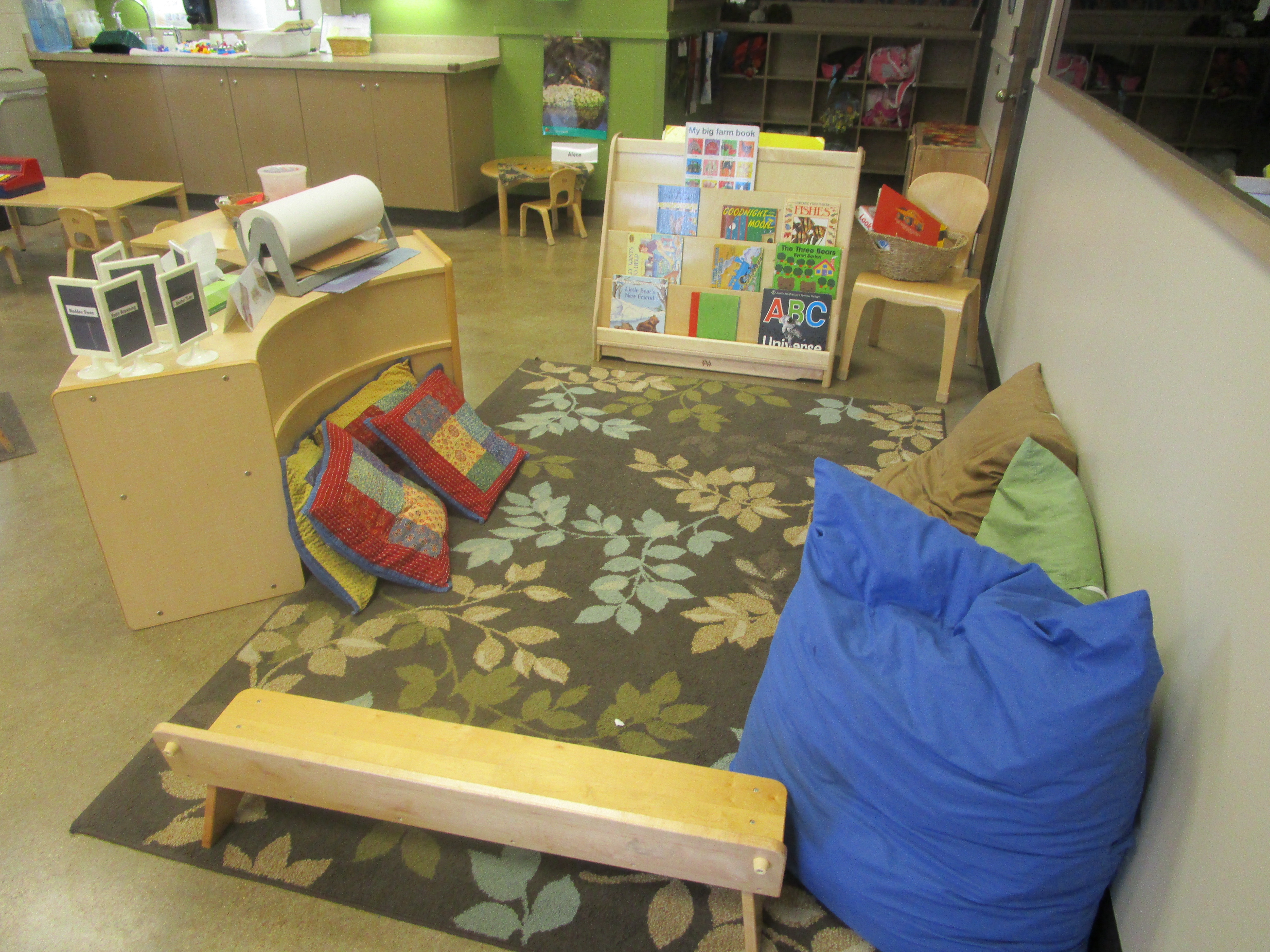 Older toddler classroom with various surfaces to sit and read.