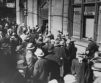 هذه الصورة عبارة عن صورة لأشخاص يصطفون خارج أحد البنوك على أمل سحب أموالهم خلال فترة الكساد الكبير.