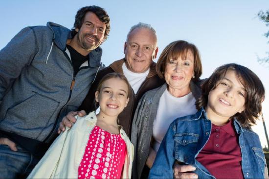 Intergenerational Latinx family smiling for the camera