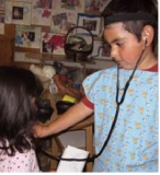 Two children playing with a stethoscope.