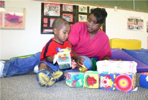 Teacher playing with a child one on one.