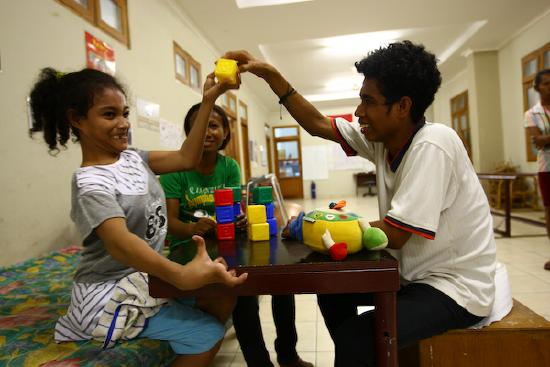 A young cerebral palsy client having physical therapy.