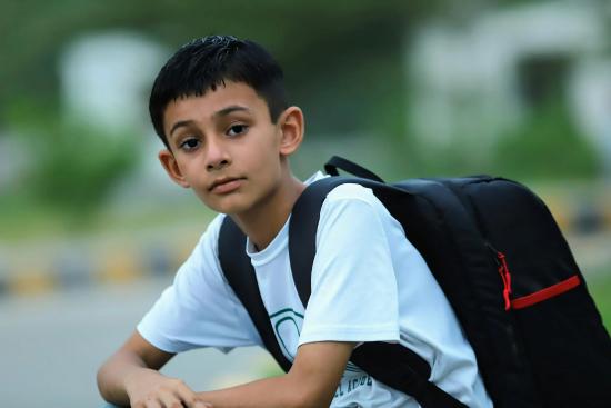 boy wearing a black backpack