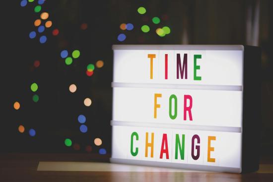 Illuminated letterboard spelling out the words "Time for Change." 