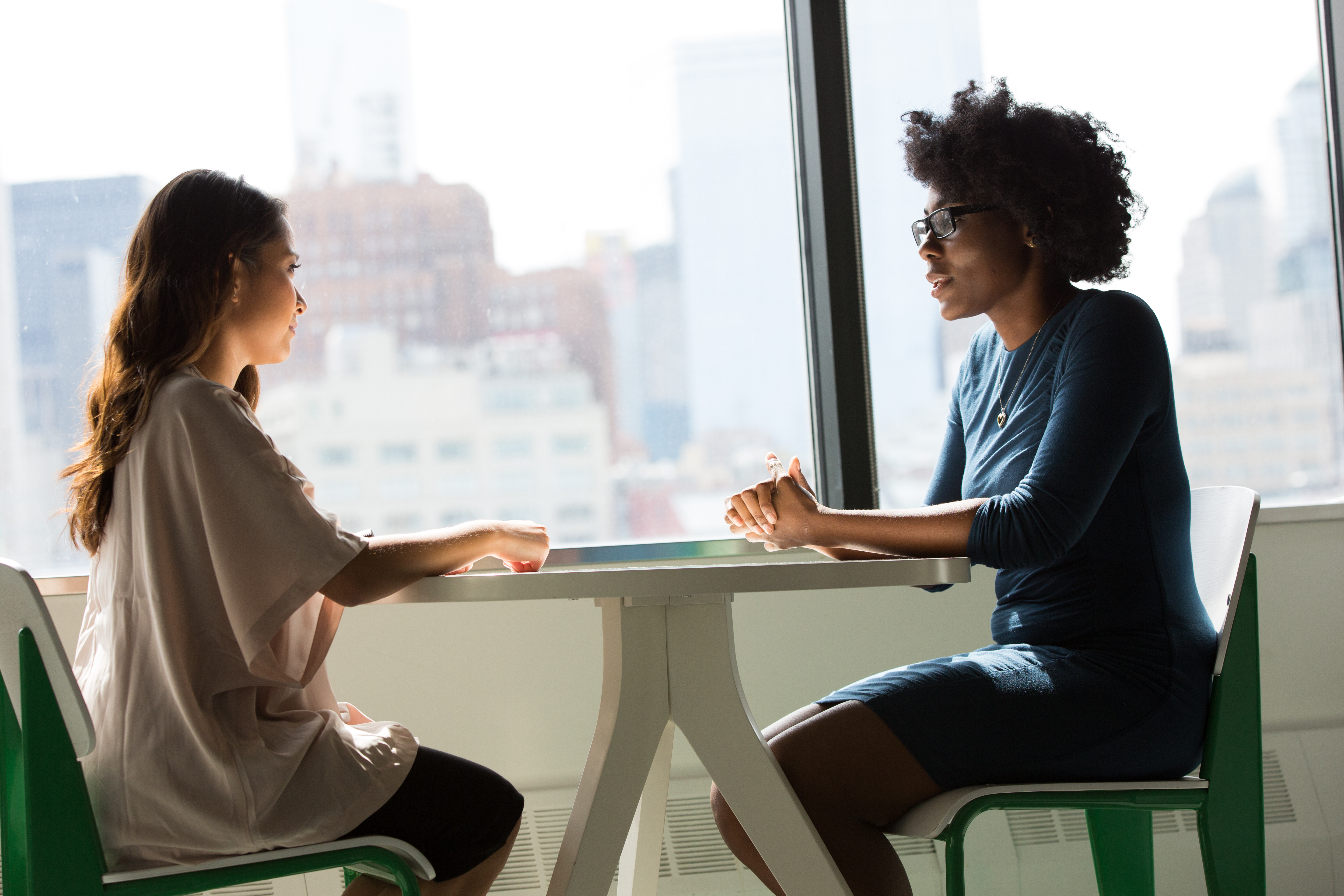 Two individuals at a table during an in-depth interview