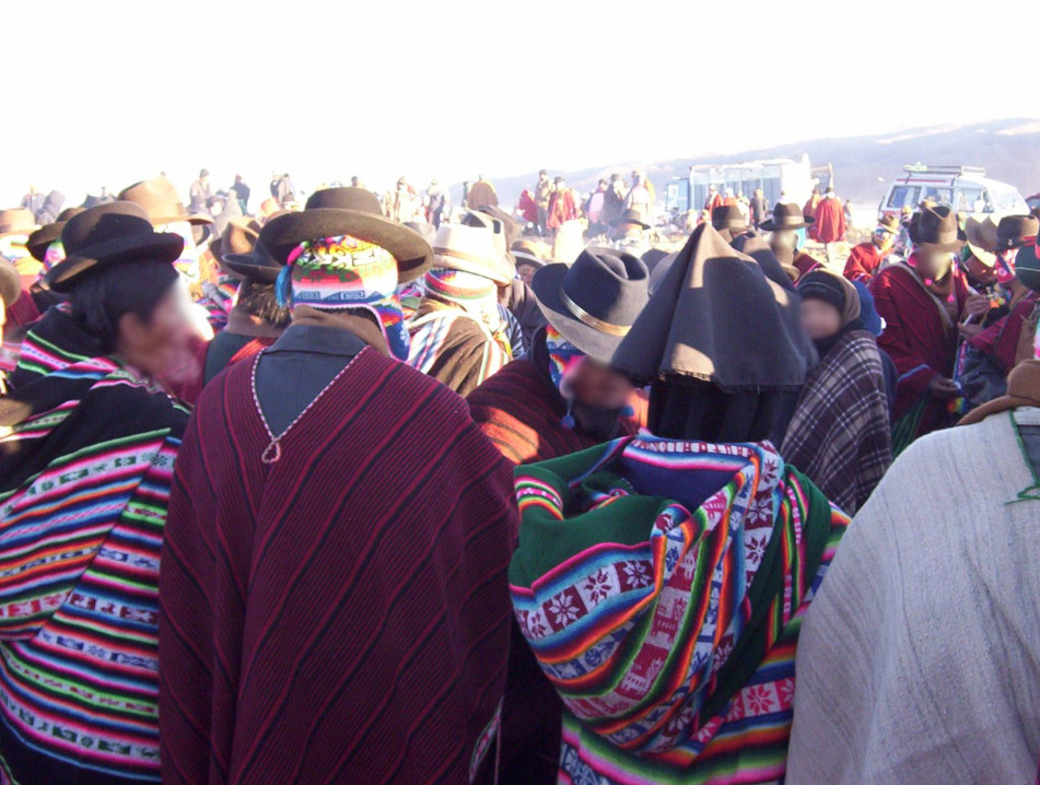 Hundreds of people dressed in traditional Andean outfits at an outdoor party.