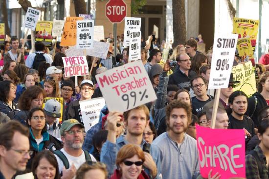 A large crowd of protesters holding sign