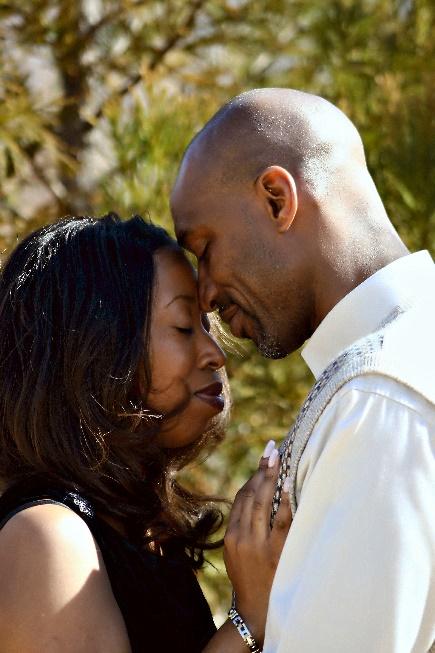 A couple holding each other so that their foreheads touch.